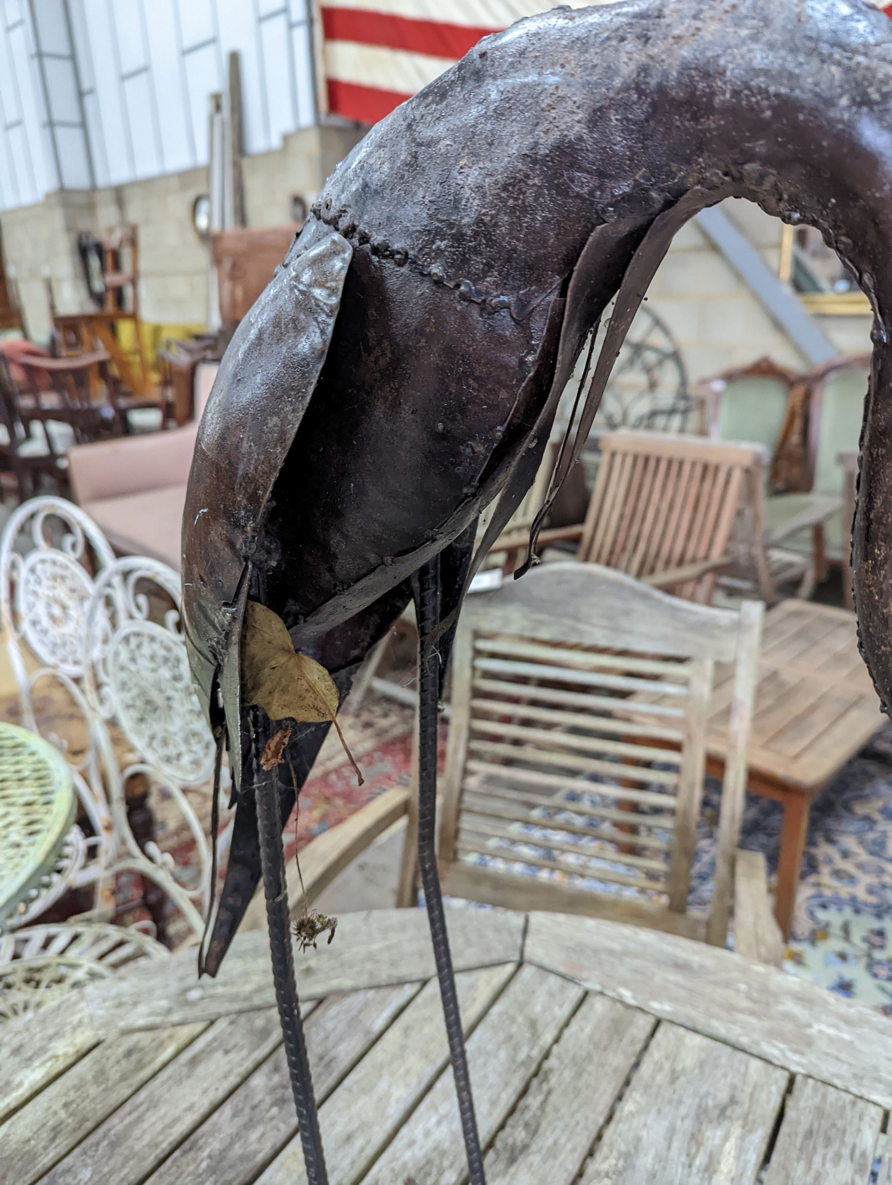 A pair of weathered metal heron garden ornaments, larger 108cm high